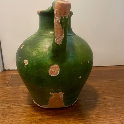 Authentic 19th-century French terracotta water jug, traditionally known as a creche a eau, featuring a rich green glaze...