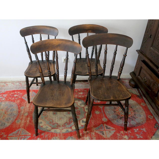Antique set of 4 solid oak farmhouse dining chairs dating from the last part of the nineteenth century. The chairs have...