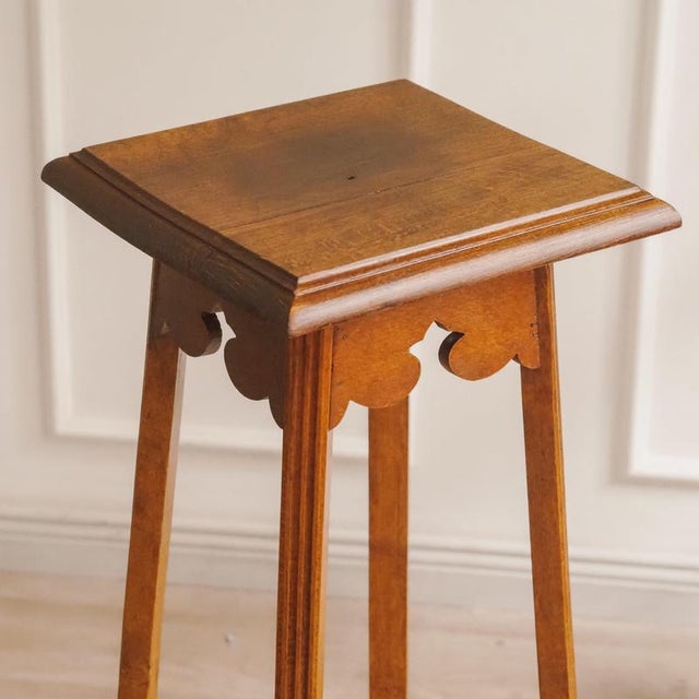 A tall, narrow side table from the Art Nouveau period, dating from around 1900. Its design is distinguished by...