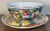 This is a Vintage Chinese Zhongguo Chao Cai Mille Fleur Porcelain Tea Bowl and Saucer Set. The tea bowl measures 2 3/8”...