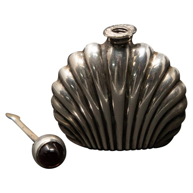 This Art Deco sterling silver perfume bottle is a gorgeous piece. Has a amethyst colored stone. The dipper is threaded to...