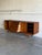 This expansive storage unit features a balanced layout with a central bank of five drawers flanked by two sets of sliding...