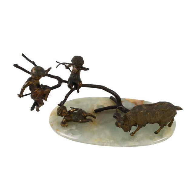 This Bronze Charging Ram Group Sculpture on Green Onyx Base is a dynamic and narrative-driven work that captures a...