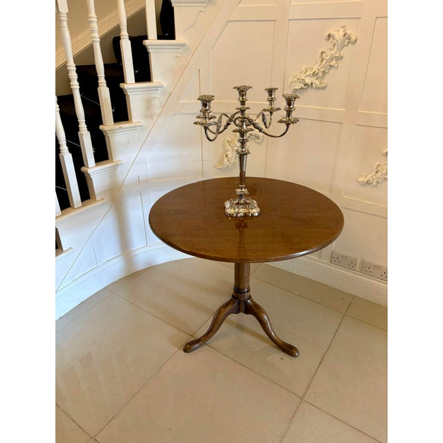 A fine Georgian figured mahogany circular tilt top table raised on a well proportioned turned pedestal with elegant tripod...