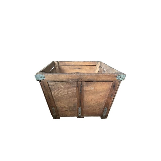 A charming, utilitarian dry goods crate. Features a wood construction reinforced with zinc metal strapping. Tapered body....