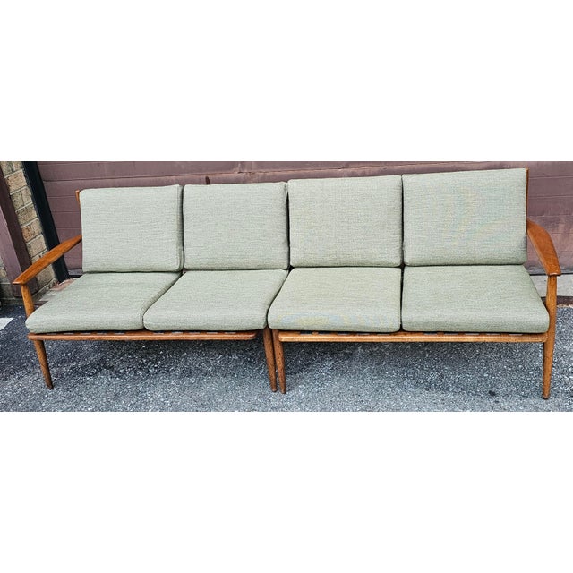 A newly reupholstered two-Piece Mid-Century Modern Teak Sofa with New Sage Green Cushions. Comes with over 3 yards of...