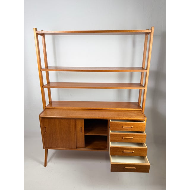 Large Danish storage unit from the 1960s, designed in the Scandinavian Modern aesthetic and crafted from teak and teak...