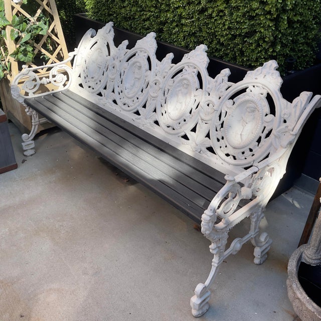 Cast Aluminum Four Seat Garden Bench, 20th c., with four pierced medallion backs over a slatted wood seat, flanked by...