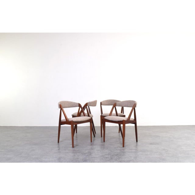 A set of four dining chairs designed by Kai Kristiansen represents one of the most recognizable designs of Danish mid-...
