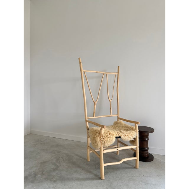 Artisan crafted, sculptural birch twig chair with woven checkerboard seat. We love this unique, one-of-a-kind chair....