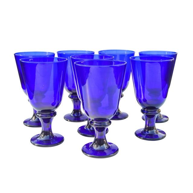Exquisite, joyful and heavy set of eight midcentury crystal stemmed glasses handblown in cobalt-blue. Exhibiting a...