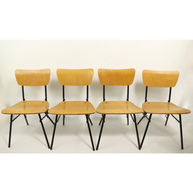 Chic architectural design game table and four chairs manufactured by Cavalier. Constructed of wood and tubular iron rods,...