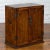 An antique Chinese elm wood side cabinet from the early 20th century, with slightly raised panels and brass hardware....