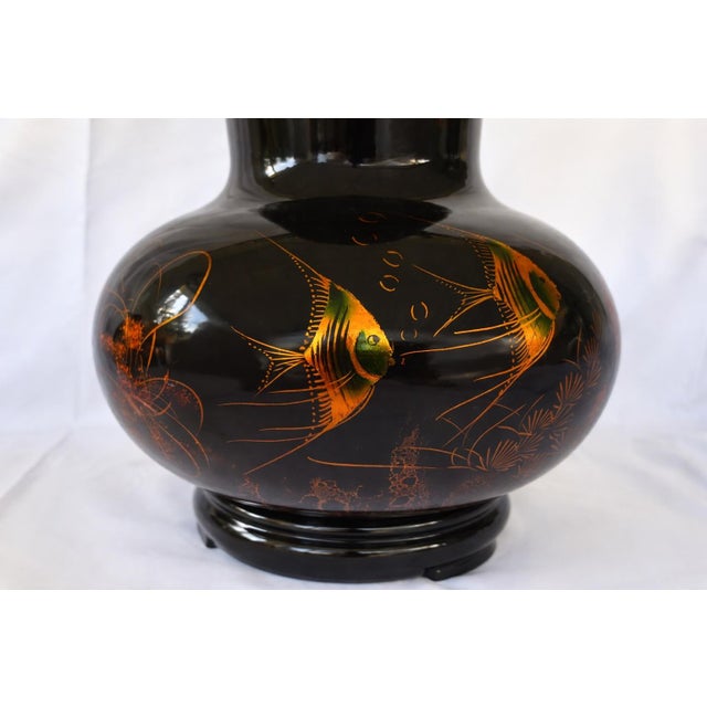 This striking vintage decorative vase is crafted from turned wood and finished in a deep, high-gloss black lacquer, richly...