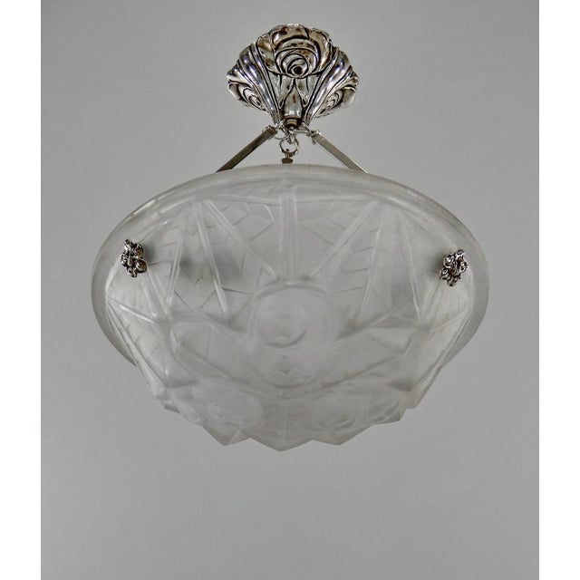 Degué A signed French Art Deco pendant light, circa 1930. The nickel-plated bronze or solid brass fixture holds a...