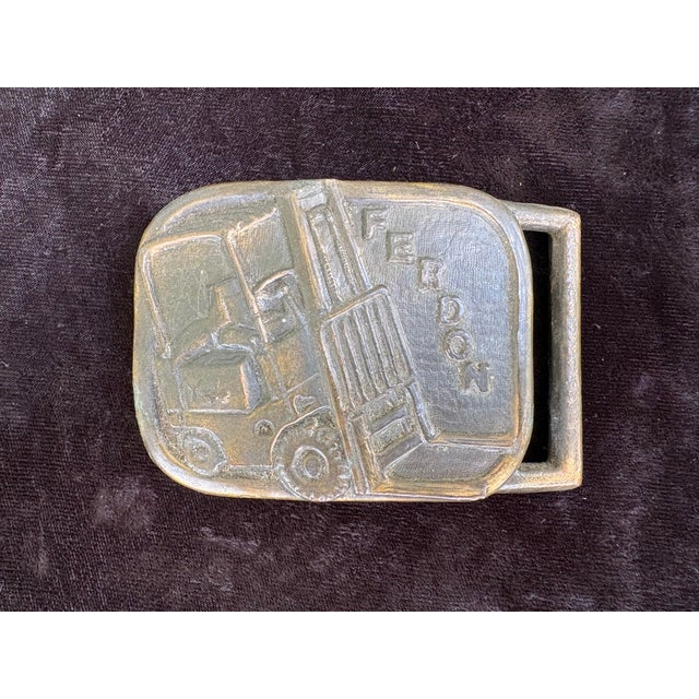 A wonderfully curated collection of six vintage brass belt buckles featuring a striking blend of Western, industrial,...