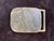 A wonderfully curated collection of six vintage brass belt buckles featuring a striking blend of Western, industrial,...