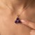 A regal three-stone design featuring round-cut natural amethysts arranged in a graceful trefoil formation, secured in a...