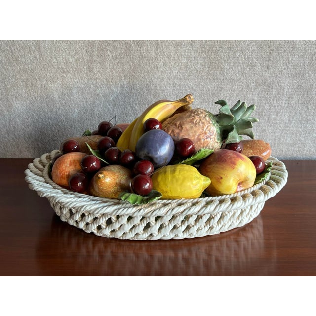 Mid 20th Century Italian Majolica ceramic fruit basket or bowl featuring apples, oranges, a plum, a pineapple, a lemon,...