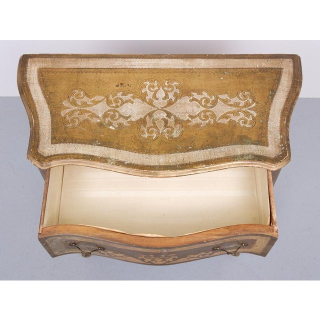 Very nice vintage Italian Florentine chest with 3 drawers with unique gold and white drawings. The curved serpentine legs...