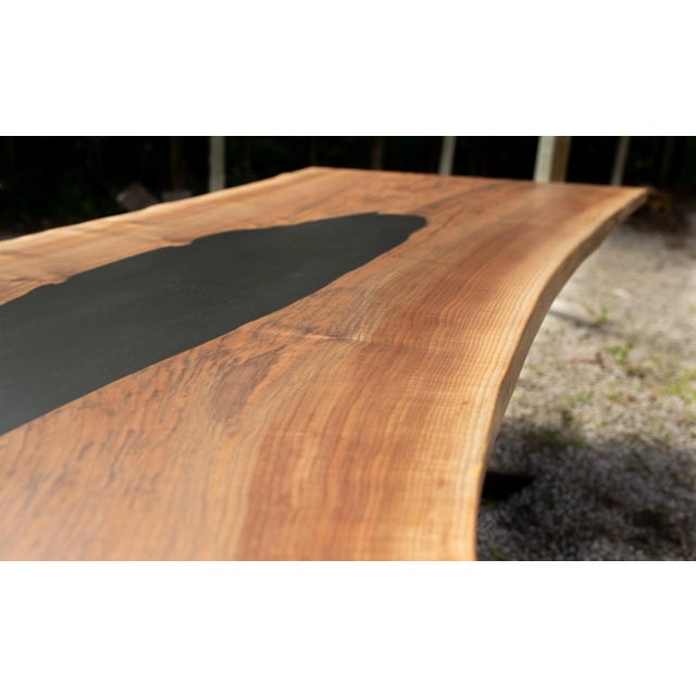 This walnut and black epoxy dining table was crafted from a highly figured single slab. The table finished out with...
