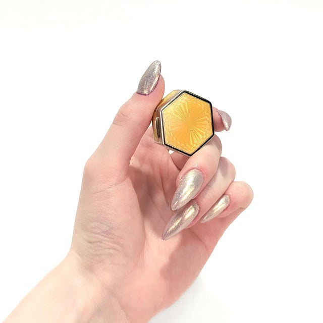 A fine antique Art Deco pill box or compact. In gilt sterling silver. In a hexagonal form with yellow guilloche and black...