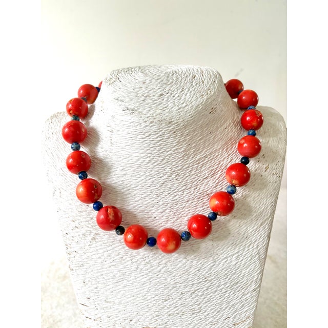 Gorgeous coral and lapis beaded necklace with gold tone clasp 12mm coral beads.