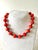 Gorgeous coral and lapis beaded necklace with gold tone clasp 12mm coral beads.