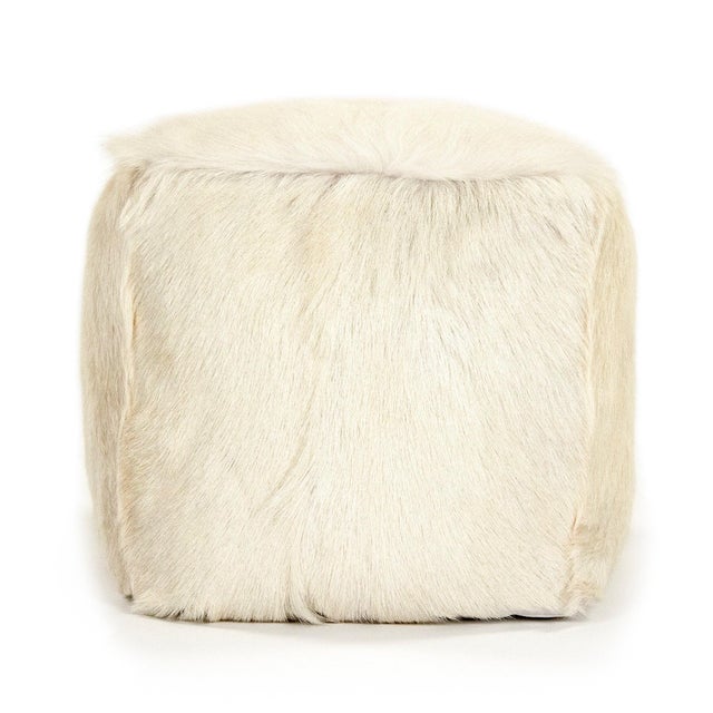 The 22" x 22" Tibetan Ivory Goat Fur Pouf from Zentique is a luxurious floor pouf covered in plush ivory Tibetan goat fur....