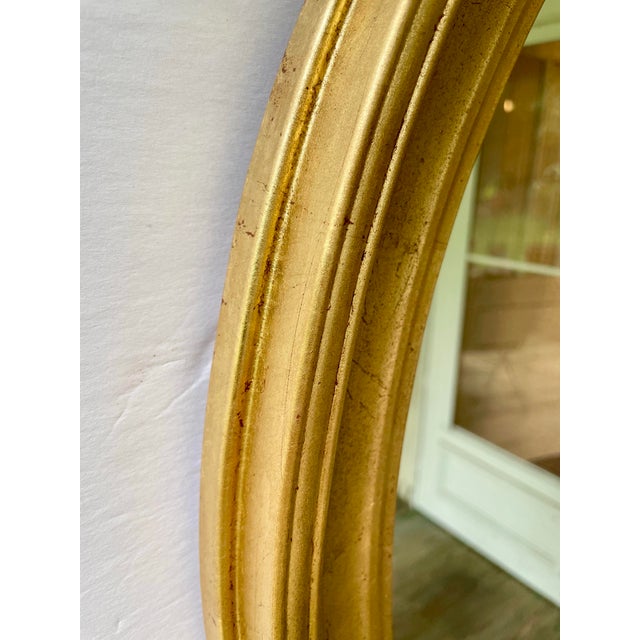 Italian gilt wood oval mirror. Great size, Measures 26.25" high x 22.25" wide x 1.5" deep. Wire on back for hanging. Some...