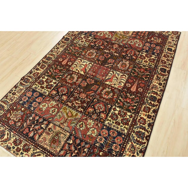 This authentic vintage traditional tribal oriental rug is hand-knotted with an all-wool pile on a cotton foundation. This...
