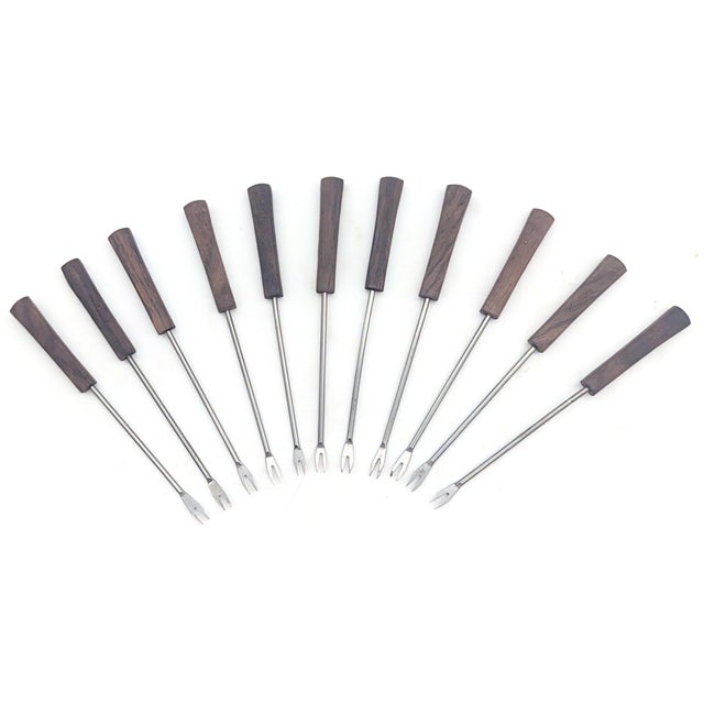 Offered is a set of 11 mid 20th Century, circa. 1950s to 1960s, hors d'oeuvres pronged picks for serving cocktail snacks....