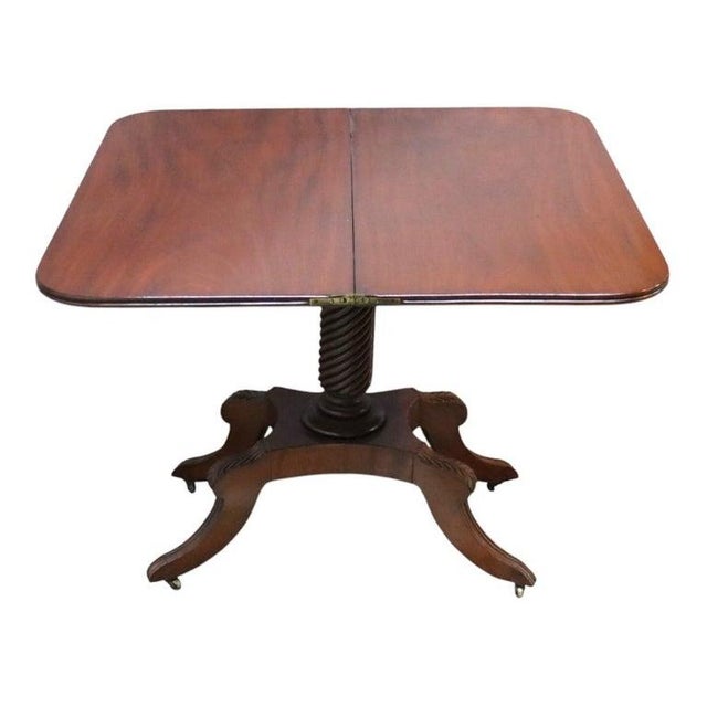 An antique Federal Sheraton card table, crafted from flame mahogany in the 19th century. This elegant piece features a...