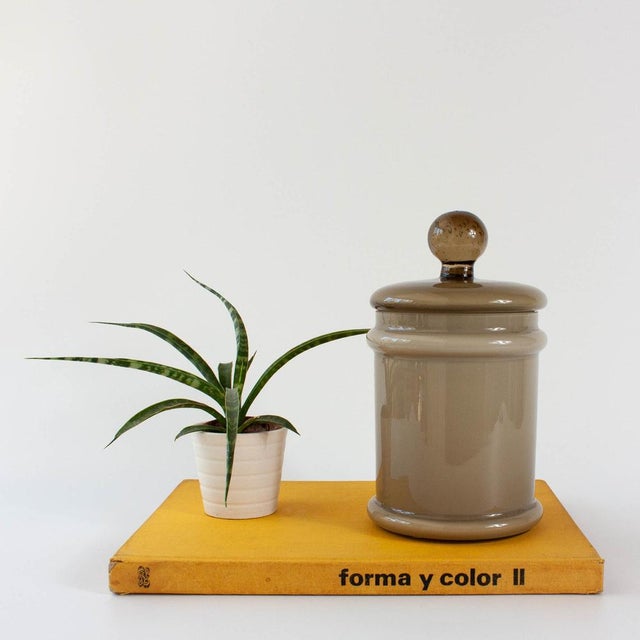 This vintage opaline glass jar with lid, produced in the 1960s in Marinha Grande, Portugal, is a sophisticated example of...