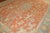 An early 20th-century orange field antique Oushak Measures: 11'7” x 15'6”.