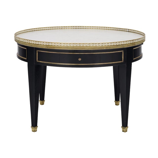 Elegant French Louis XVI style bouillotte coffee table, featuring a finely veined Carrara marble top framed by a delicate...