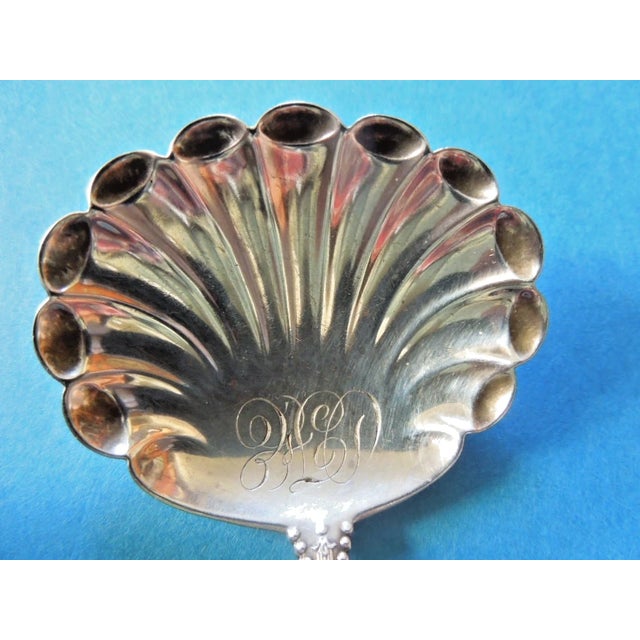 This is a beautiful Dominick & Haff sterling silver bon bon spoon in the Charles II pattern. It features a scalloped bowl,...