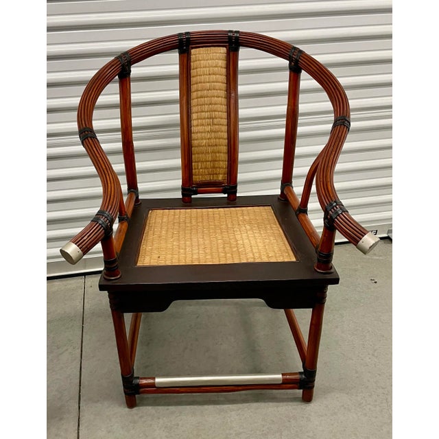 An exceptional pair of bamboo, rattan and cane club chairs Ming Style. Palecek high-end furniture company with a...