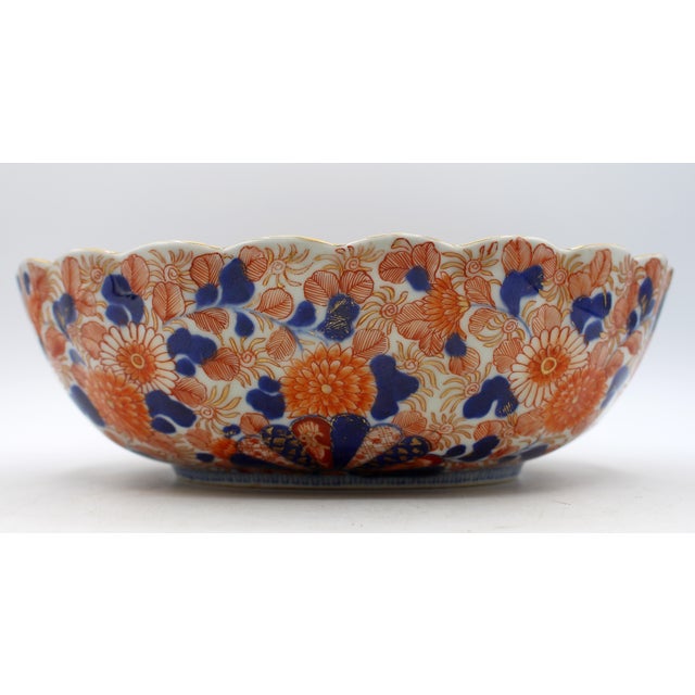 Japanese Imari oval scalloped bowl, circa 1860s. Meiji period porcelain. Exuberantly decorated with fans, chrysanthemums,...