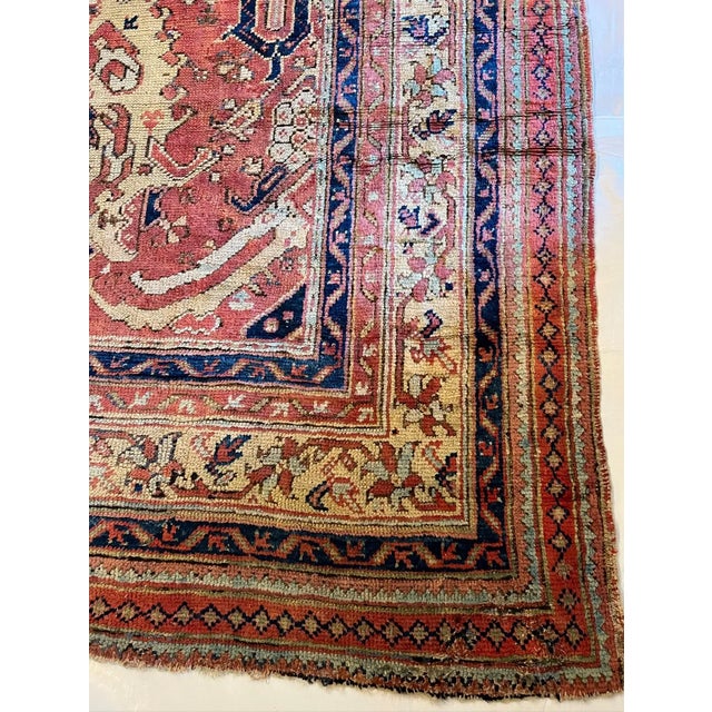 Woven in the Oushak tradition of western Turkey during the early 20th century, this antique rug represents the...
