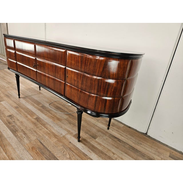 An elegant 1950s Italian bar cabinet, attributed to Vittorio Dassi, characterized by a strong presence and refined...