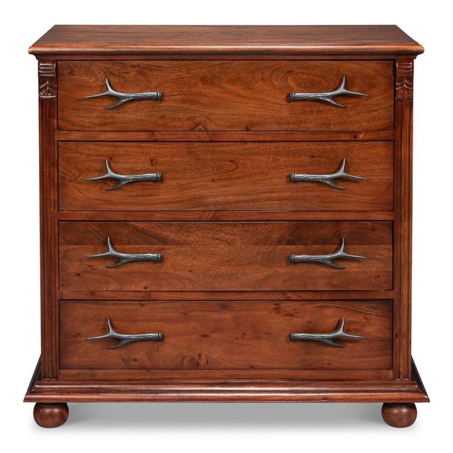 Cast antler-shaped pulls bring a sculptural, woodland detail to every drawer front. They sit against acacia finished in a...
