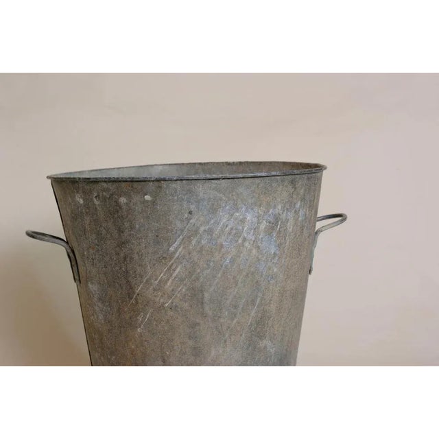 A container that can be used as a log holder near the fireplace or as a planter for a shrub