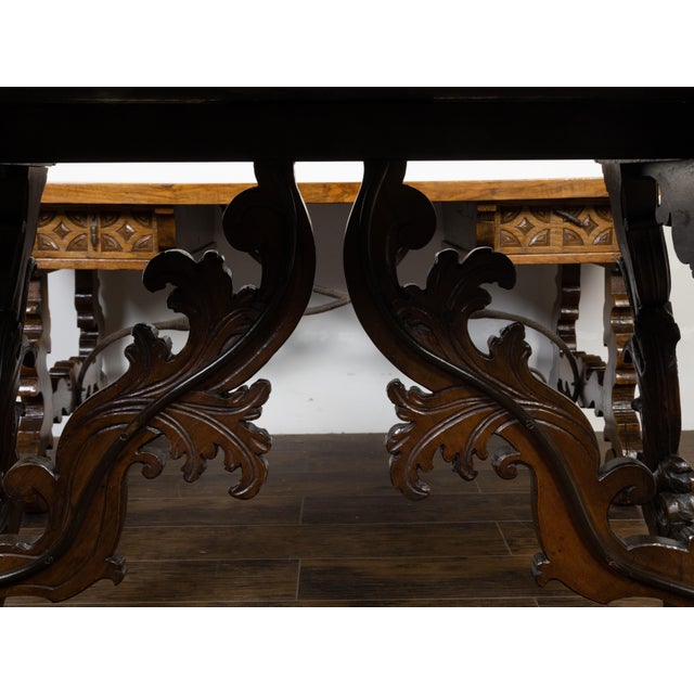 An Italian Baroque style walnut Fratino console table from the 18th century, with carved lyre-shaped trestle base,...