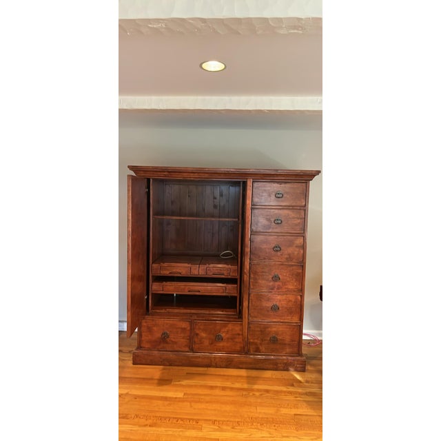 Beautiful solid wood apothecary style cabinet with pullout desk, file drawers and retractable doors. Great storage, work...