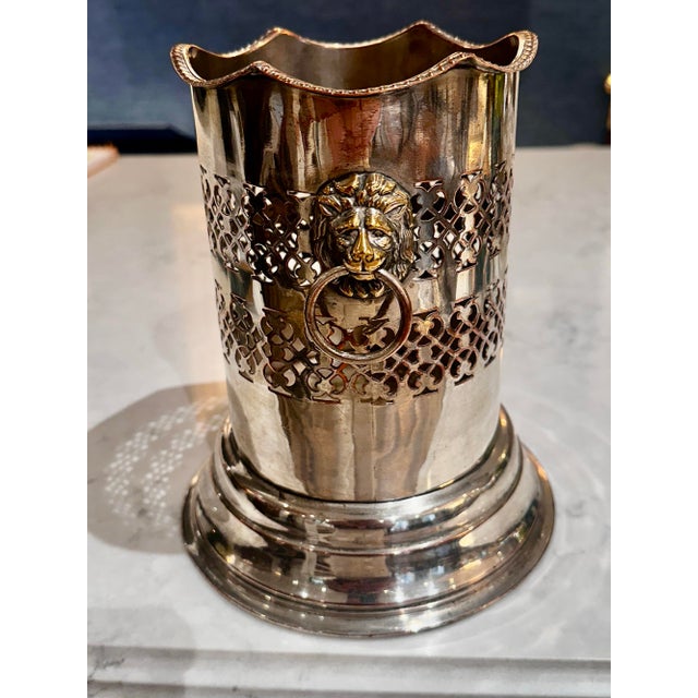 Elevate your wine service for guests with this early 1900's silver plate over copper bottle holder. The pierced sides with...