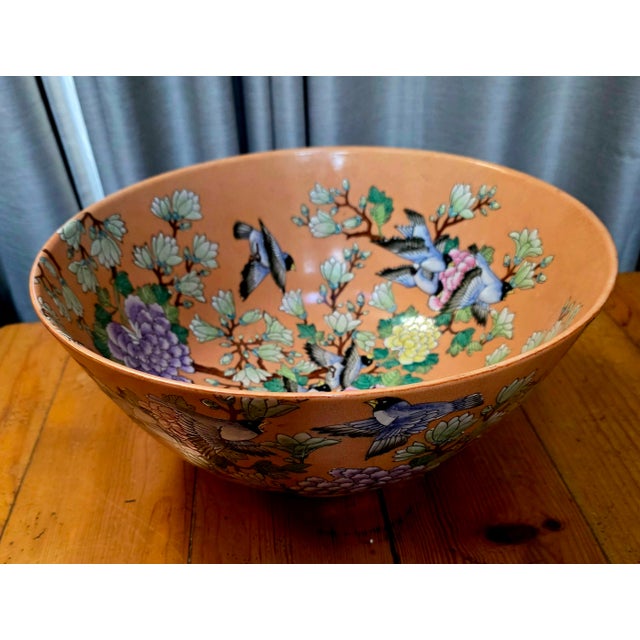 This item is a Chinese porcelain bowl with an orange-to-coral ground, hand-painted with Famille Rose or Famille Verte...