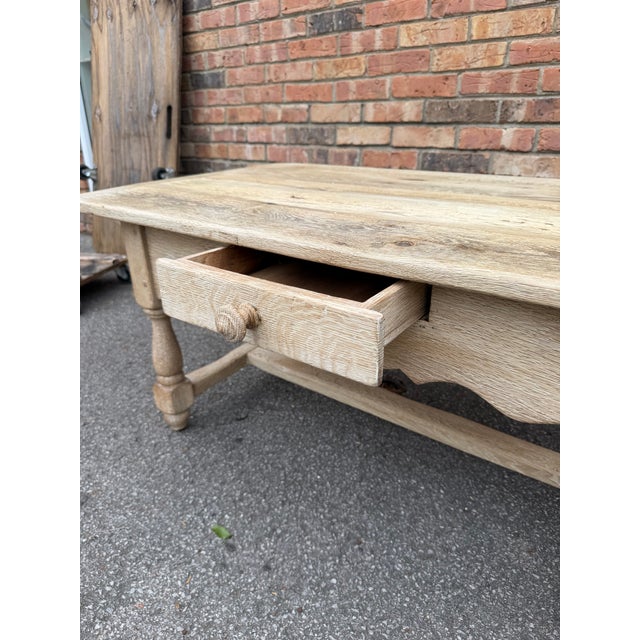 This is a lovely example of a scrubbed oak coffee table. This table is a very solid piece with thick board top, single...