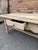 This is a lovely example of a scrubbed oak coffee table. This table is a very solid piece with thick board top, single...
