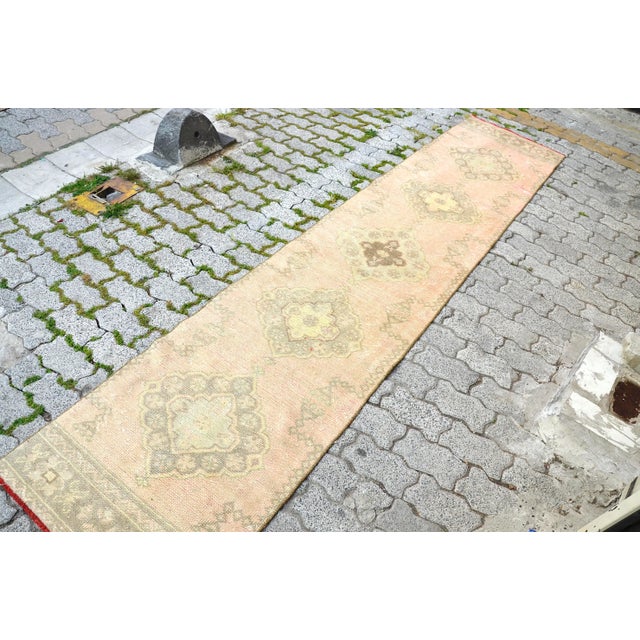 This is a vintage Turkish Oushak rug from the 1960s. The piece was hand-knotted.